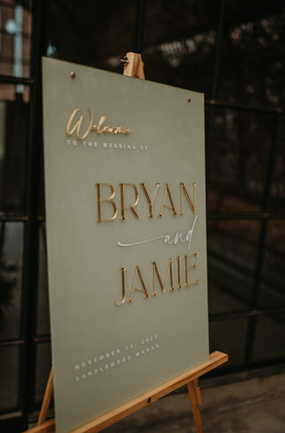 Wedding invitation card on a stand with 'Bryan and Jamie' text