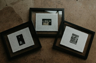 Three framed pictures on a textured brown surface